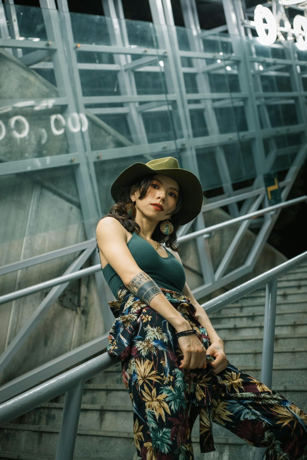 woman in black hat and black and yellow floral sleeveless dress