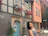 Smiling young woman standing in front of a cozy German apartment building.