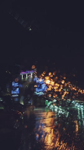 An urban night scene with colorful city lights and reflections