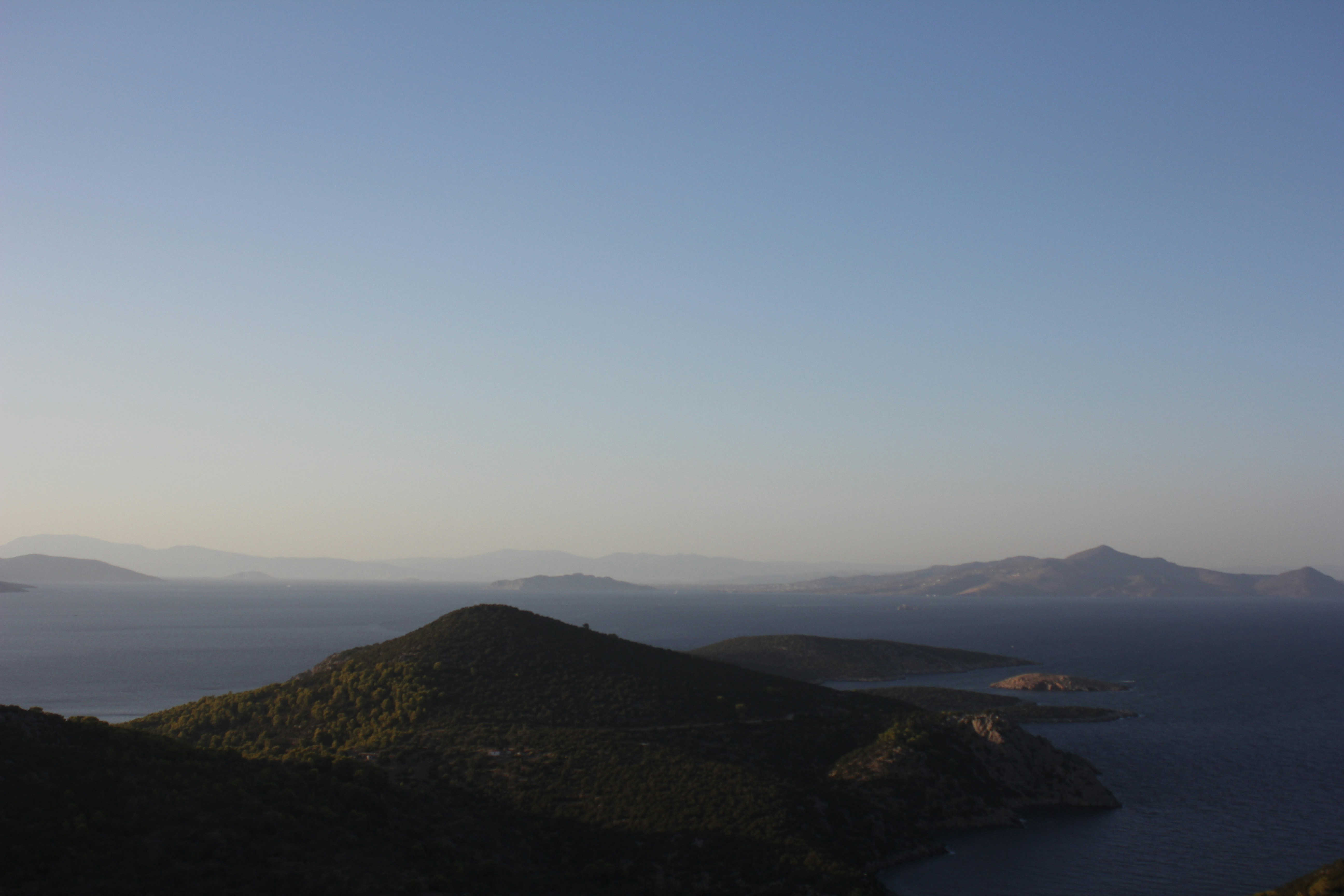 brown mountains near body of water during daytime