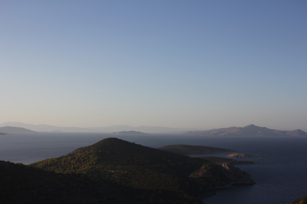 brown mountains near body of water during daytime