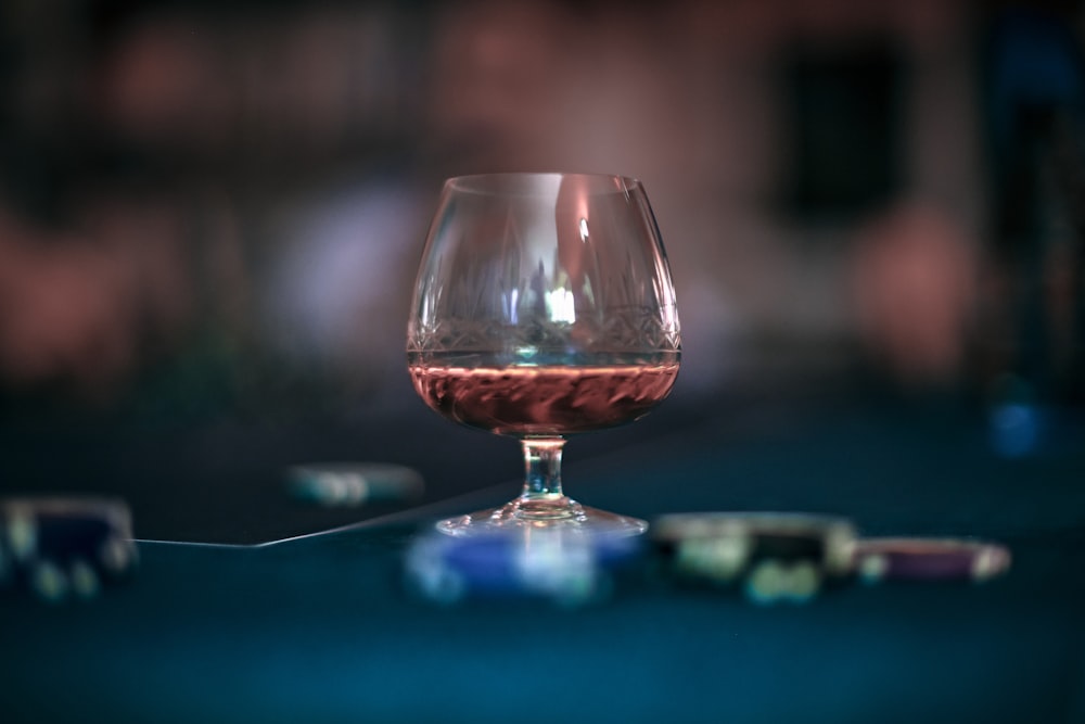 clear wine glass on blue table