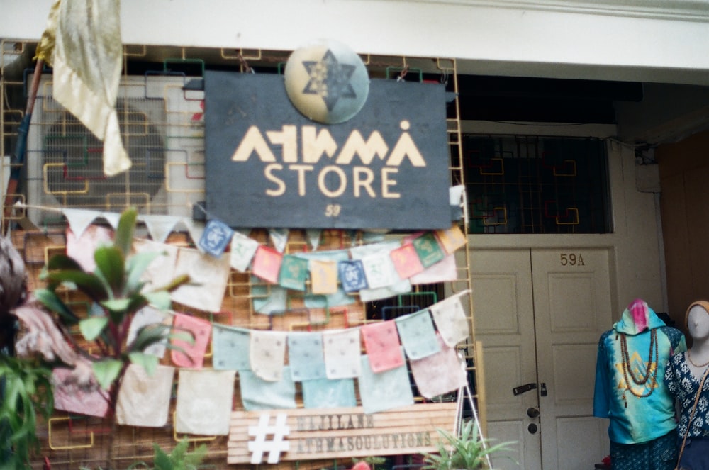 a store front with clothes hanging on a line