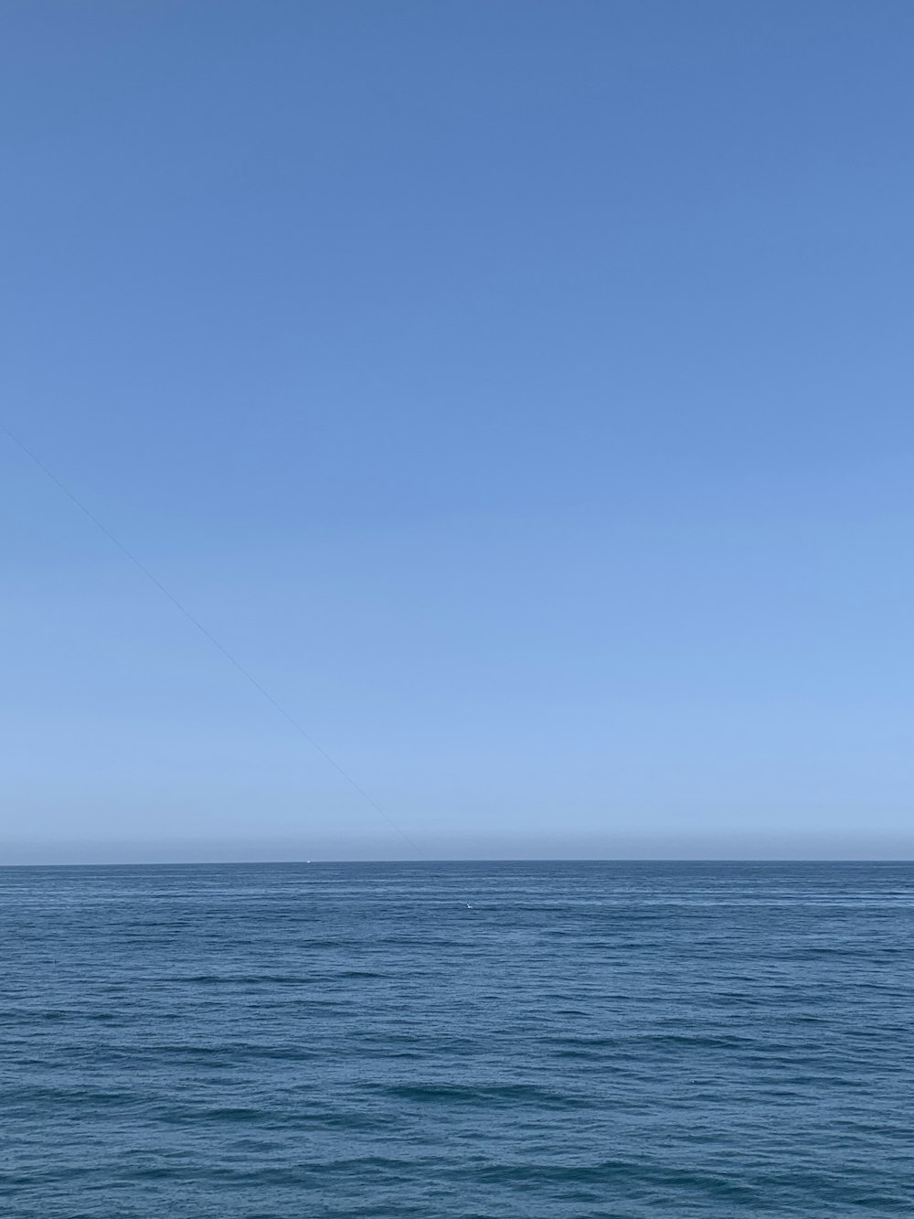 blue ocean under blue sky during daytime