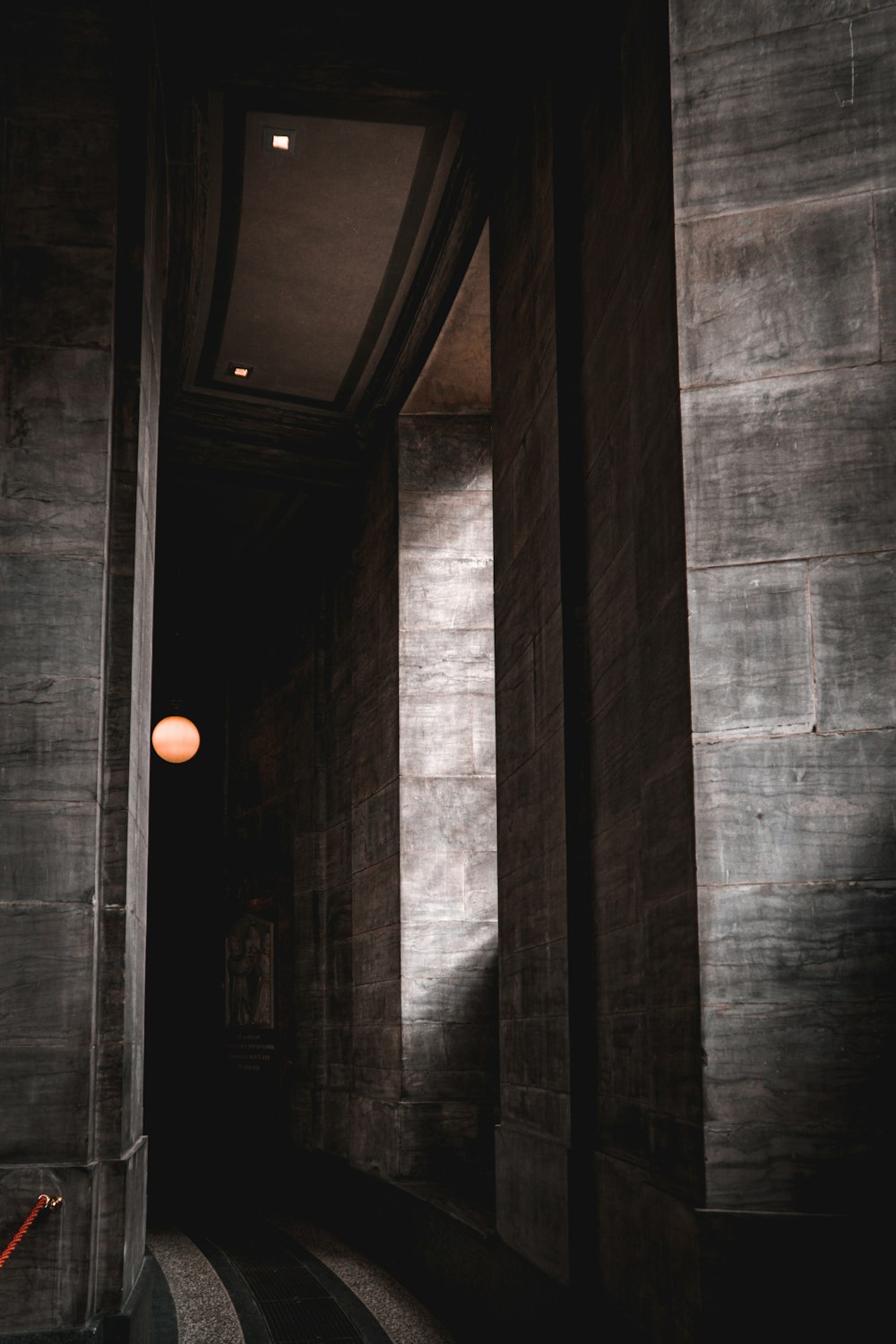 white light bulb on gray concrete wall