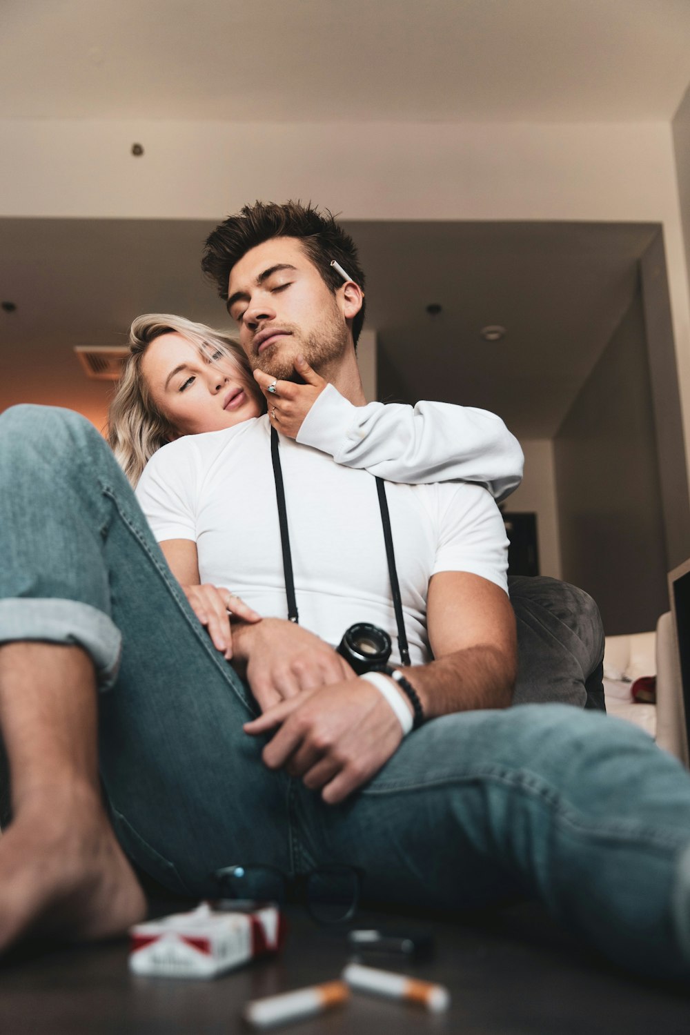 man in white polo shirt sitting beside woman in blue denim jacket