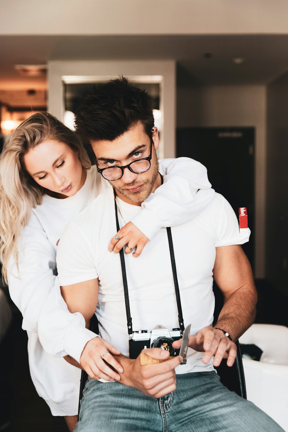 woman in white polo shirt holding black dslr camera