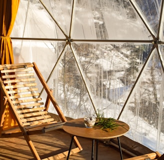 brown wooden folding chairs inside a glass room