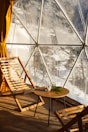 Guests enjoying a warm drink inside the glass igloo while gazing at the night sky.