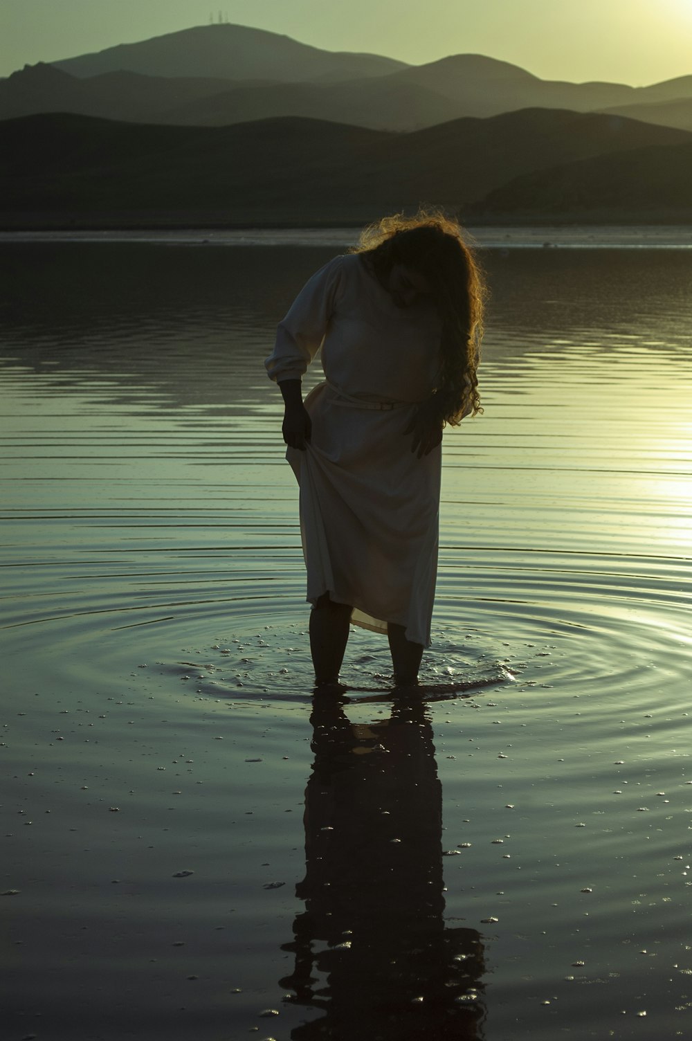 woman in white dress standing on water during daytime