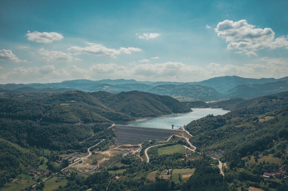 aerial view of green mountains and body of water during daytime