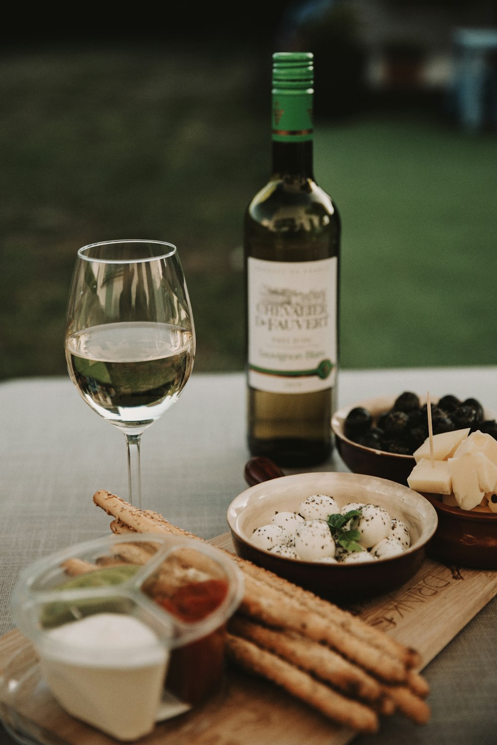 wine bottle beside wine glass on table