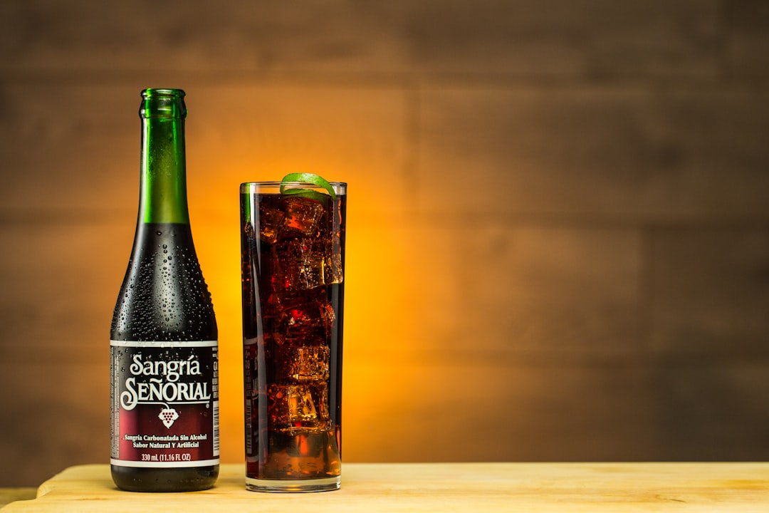 black and gold labeled bottle, Sangria Senorial Cocktail served cold with lime