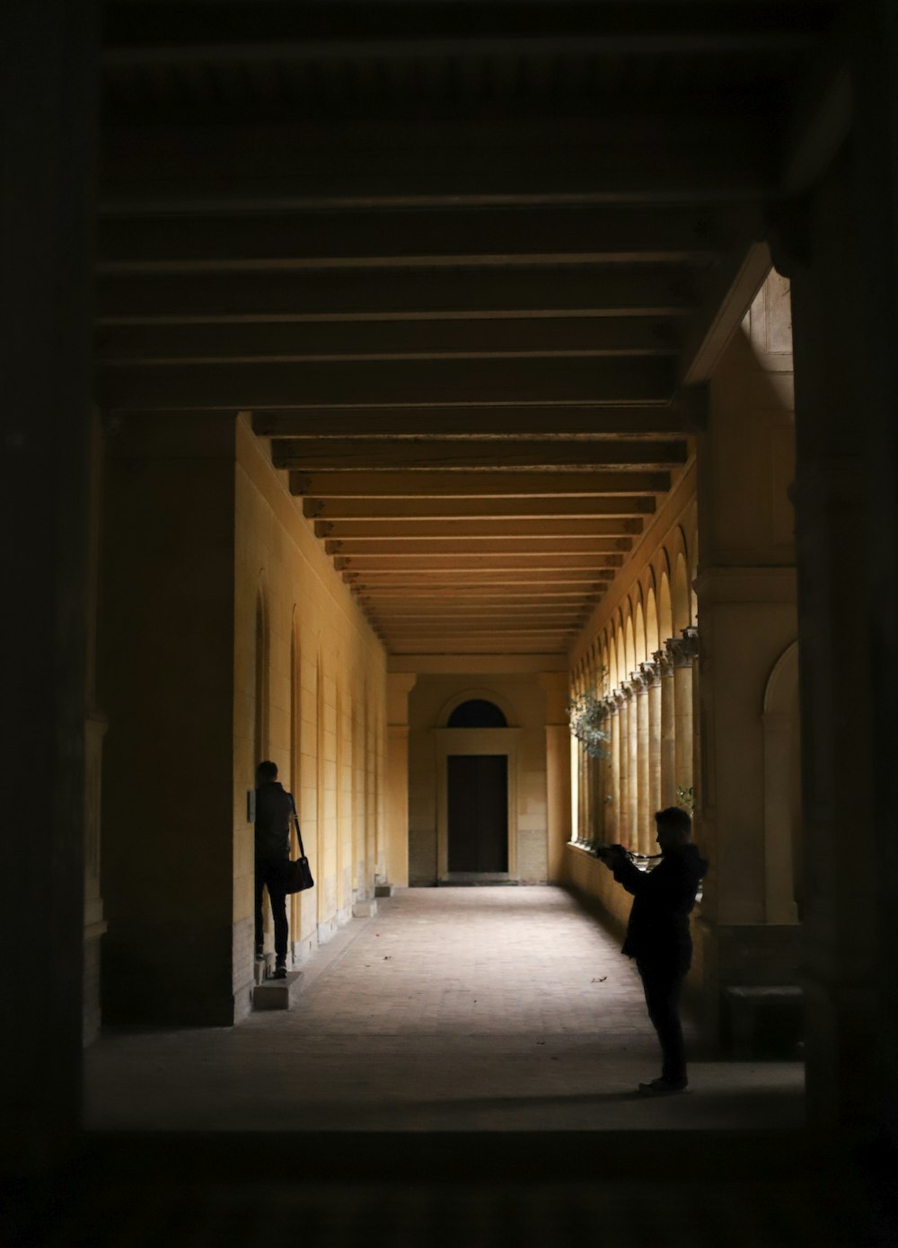 silhouette of person walking on hallway