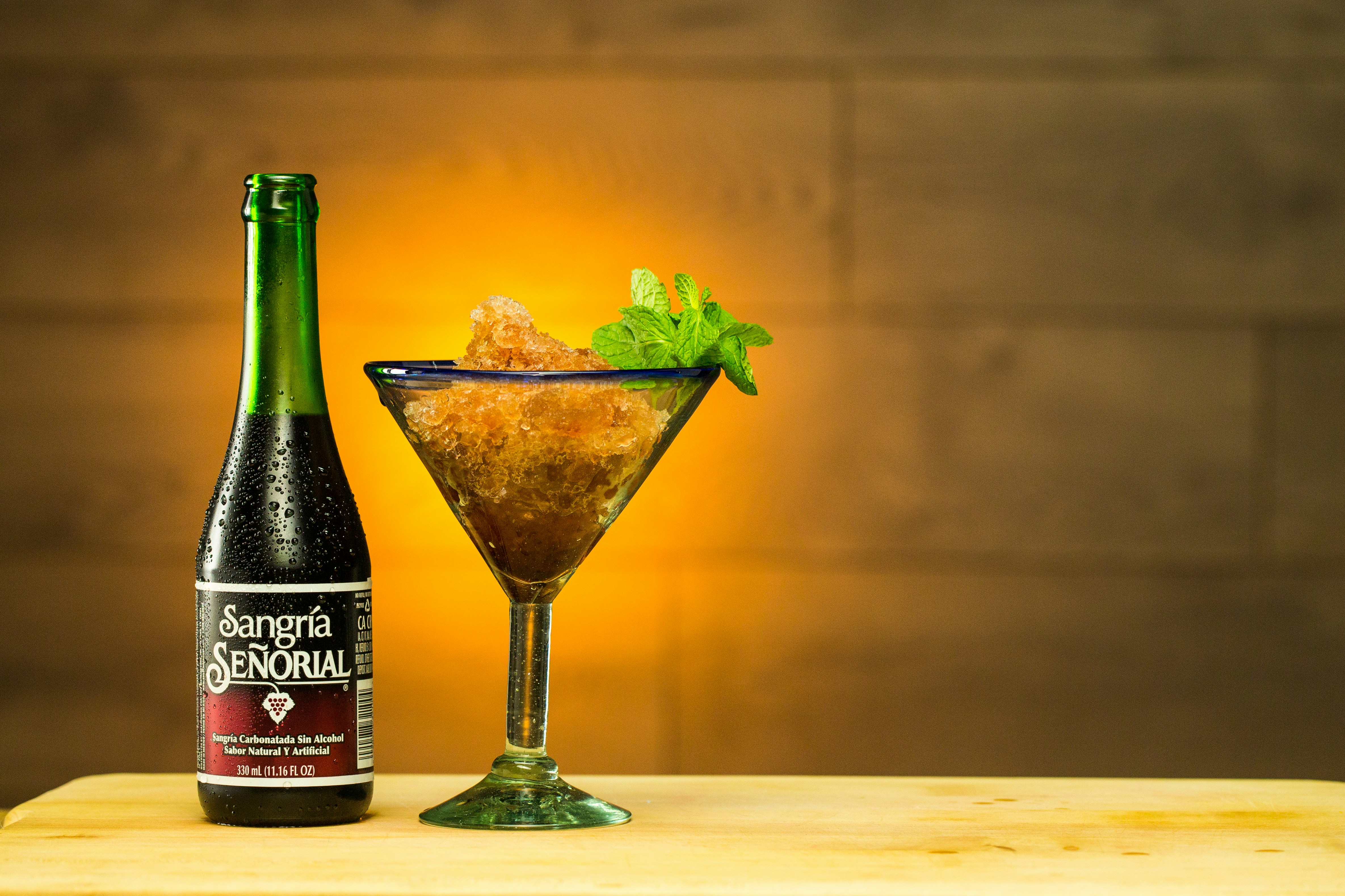 green glass bottle beside clear martini glass, Sangria Senorial Frozen Mint Cocktail