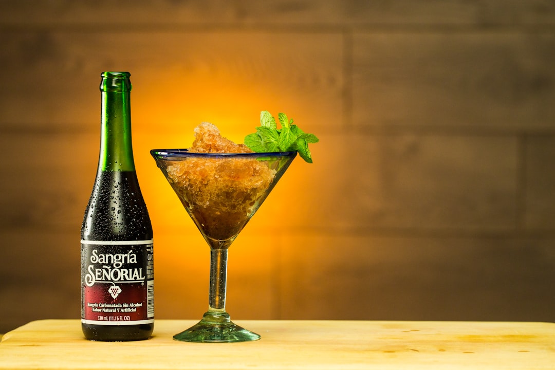 green glass bottle beside clear martini glass, Sangria Senorial Frozen Mint Cocktail