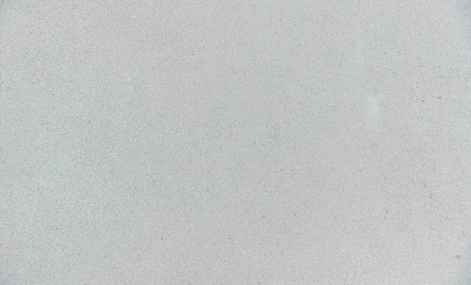 A smooth light grey concrete surface with a fine granular texture