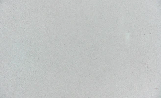 A smooth light grey concrete surface with a fine granular texture