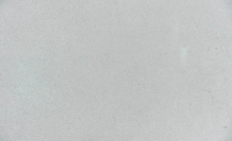 A smooth light grey concrete surface with a fine granular texture