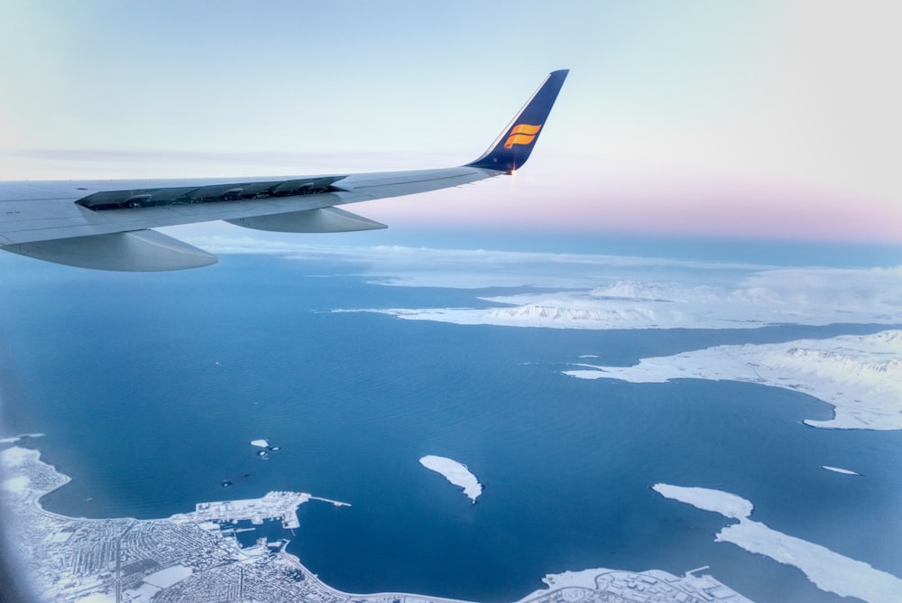 airplane wing over the clouds during daytime