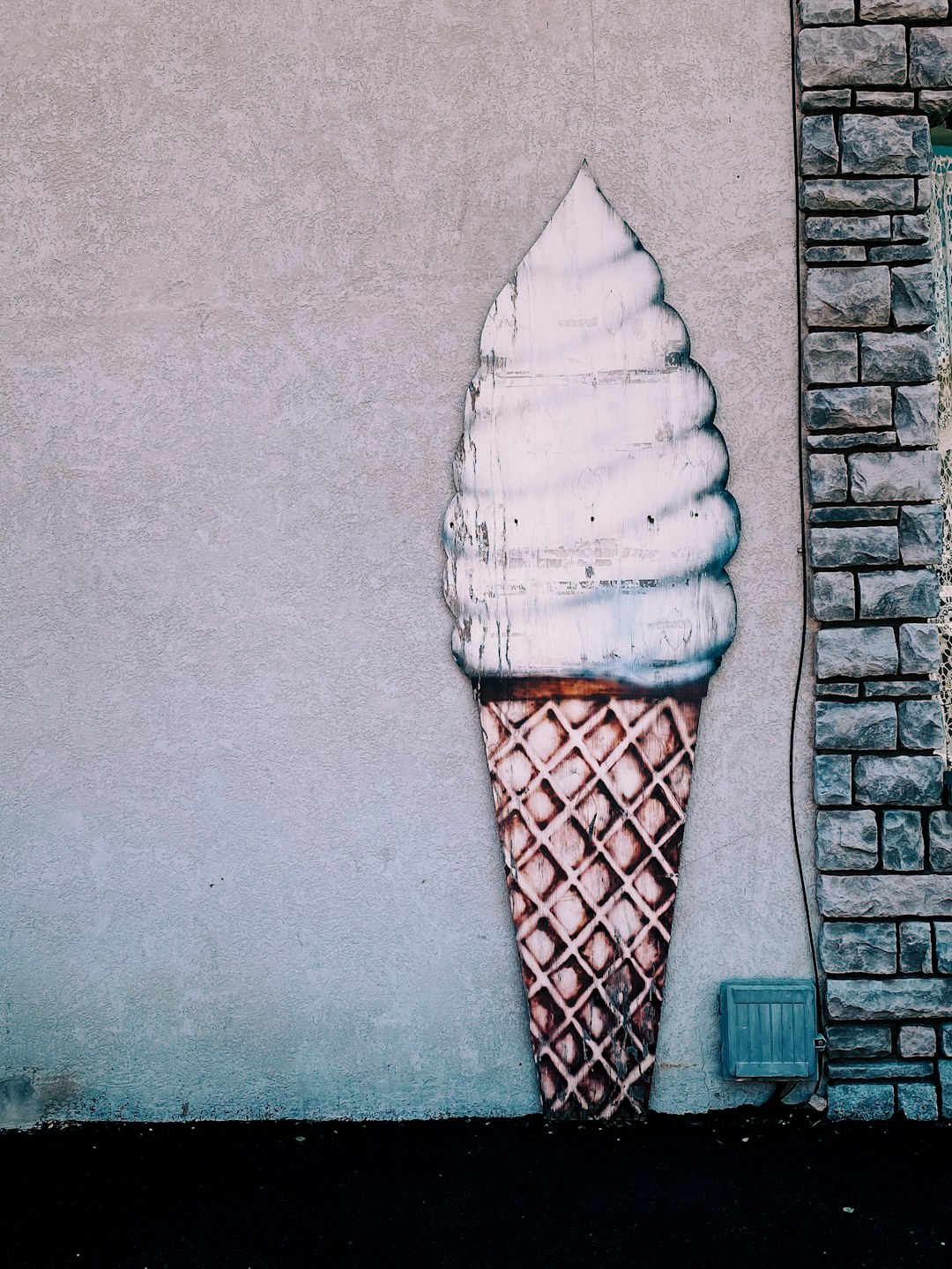 ice cream cone on brown brick wall