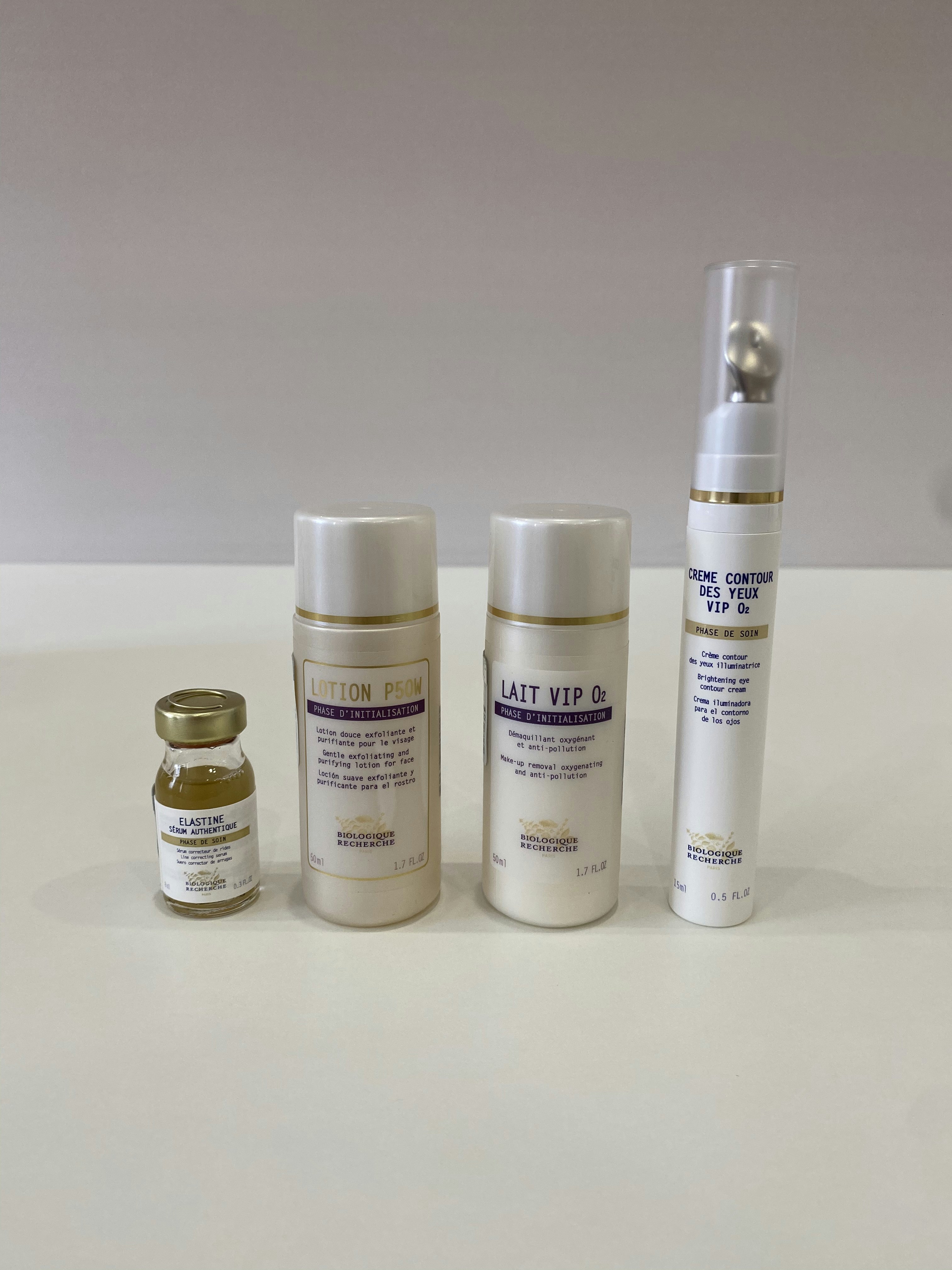 White serum bottle with minimal packaging on clean white background, Korean skincare