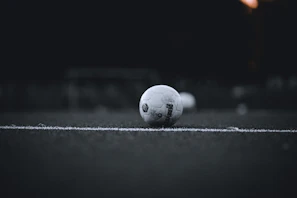 A quiet moment of focus as a teenager lines up a free kick on a dusty soccer field
