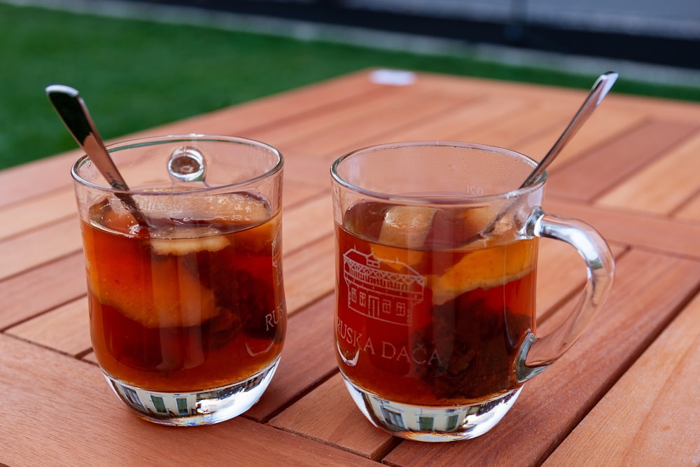 clear glass mug with brown liquid