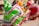 Vibrant dancers in traditional Mexican attire perform, their colorful skirts swirling in mid-motion. The focus is on the detailed patterns and bright colors of their outfits.