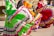Vibrant dancers in traditional Mexican attire perform, their colorful skirts swirling in mid-motion. The focus is on the detailed patterns and bright colors of their outfits.