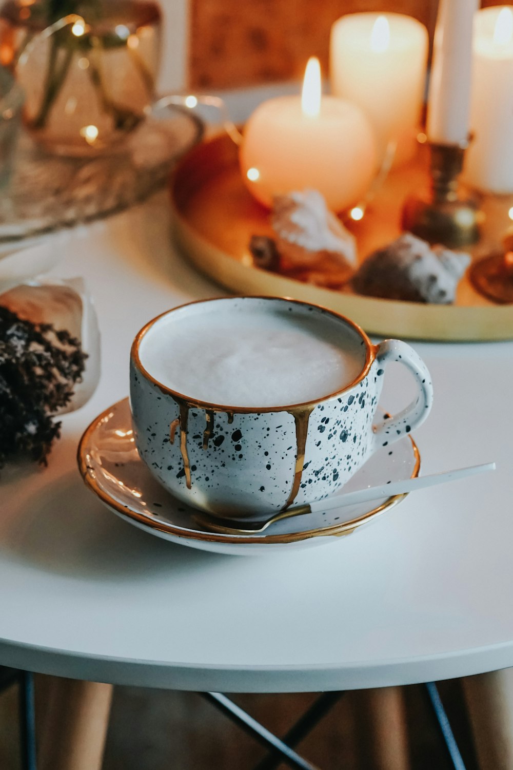 white and blue ceramic teacup on white ceramic saucer