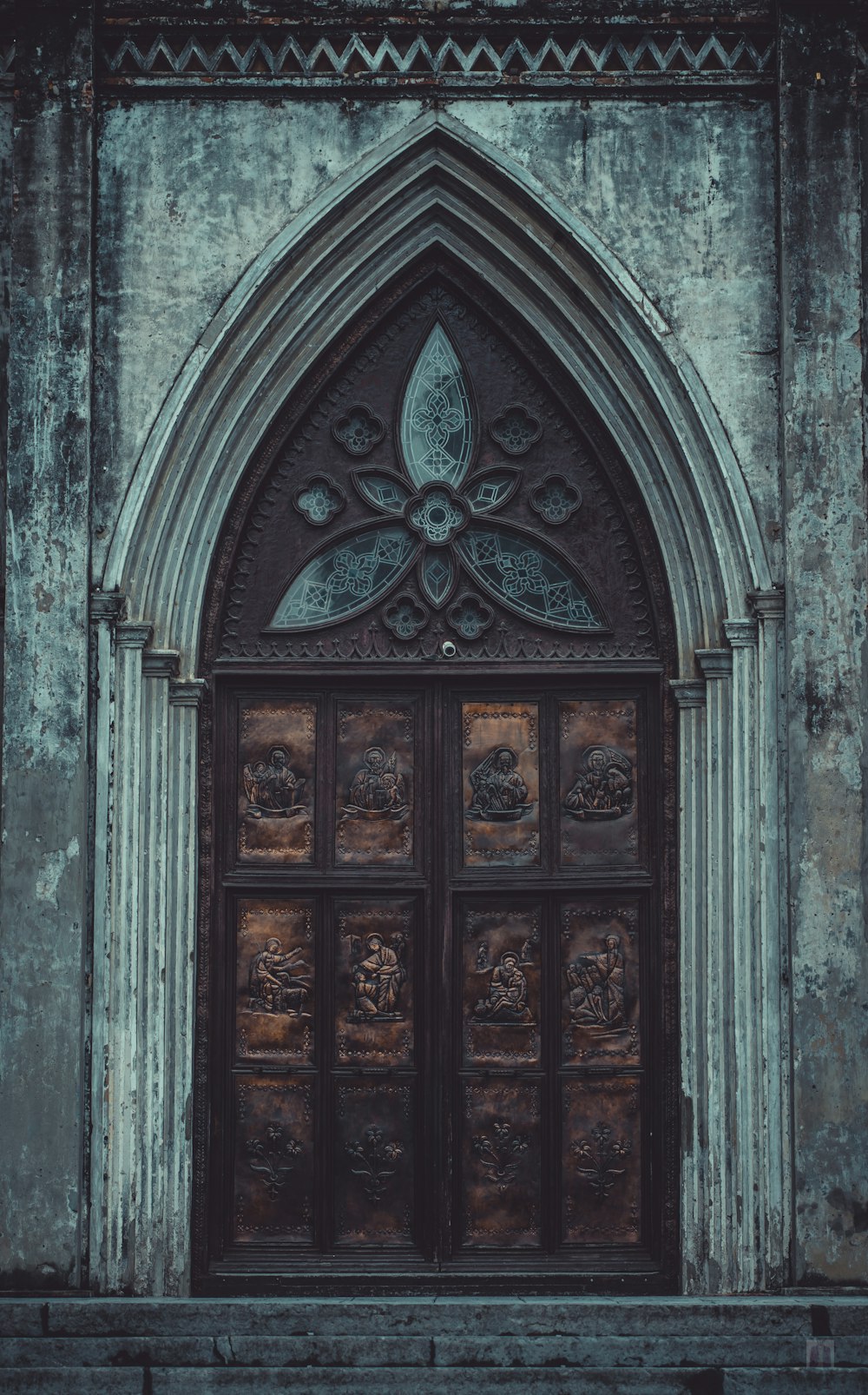 brown wooden door on gray concrete wall