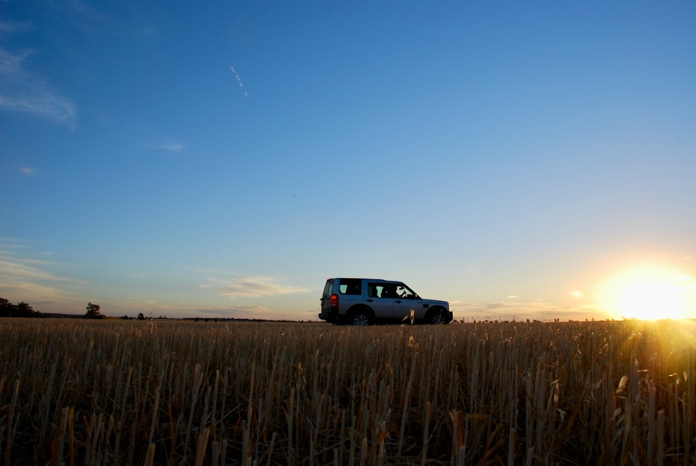 black suv on brown field during daytime