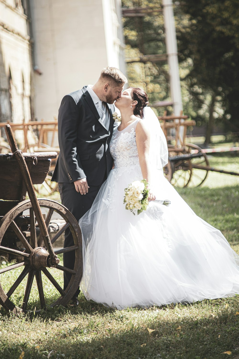 man in black suit and woman in white wedding dress