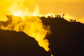 A dramatic battlefield scene with soldiers silhouetted against a smoky sky.