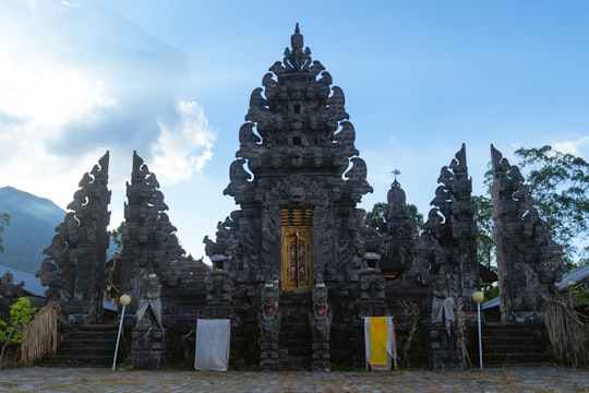 gray concrete temple under blue sky during daytime in Batur Natural Hot Spring Indonesia