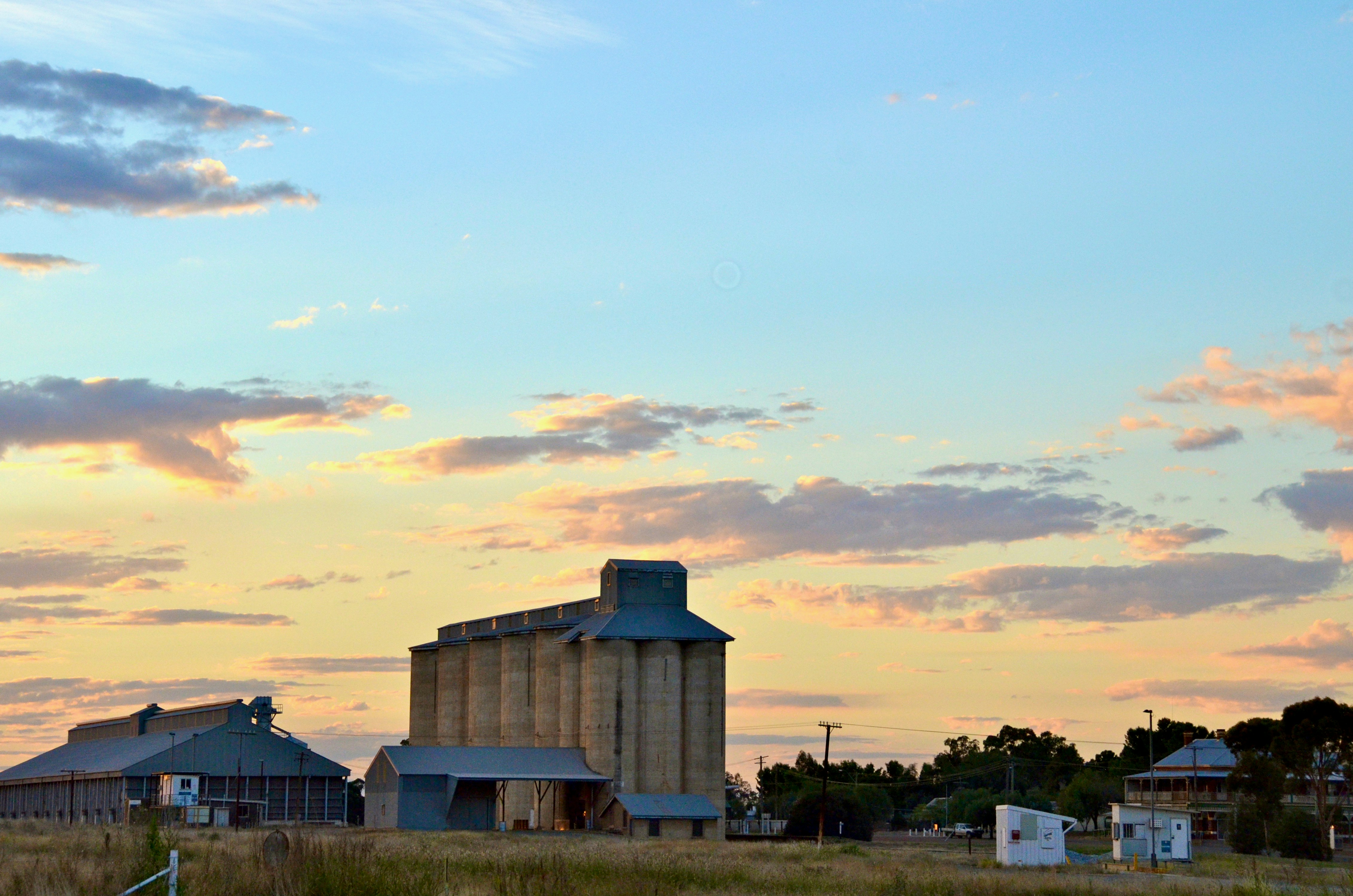Large grain silos against a clear sky.
