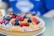 A vibrant fruit tart topped with fresh berries and kiwi slices.