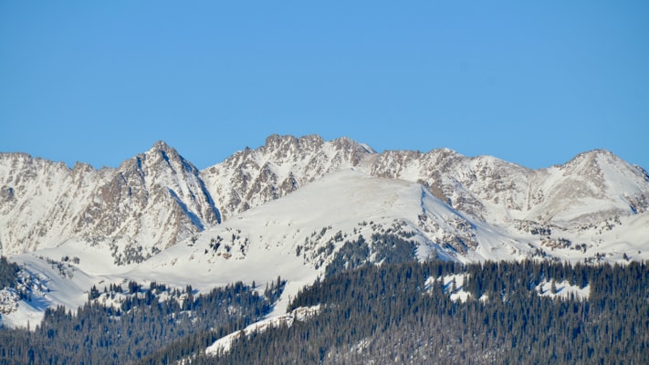 Snow-covered Gore Range near Vail under blue sky