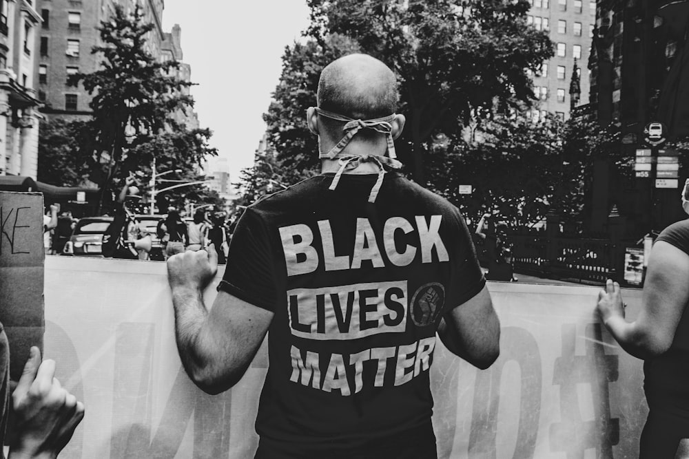 a man wearing a black lives matter shirt