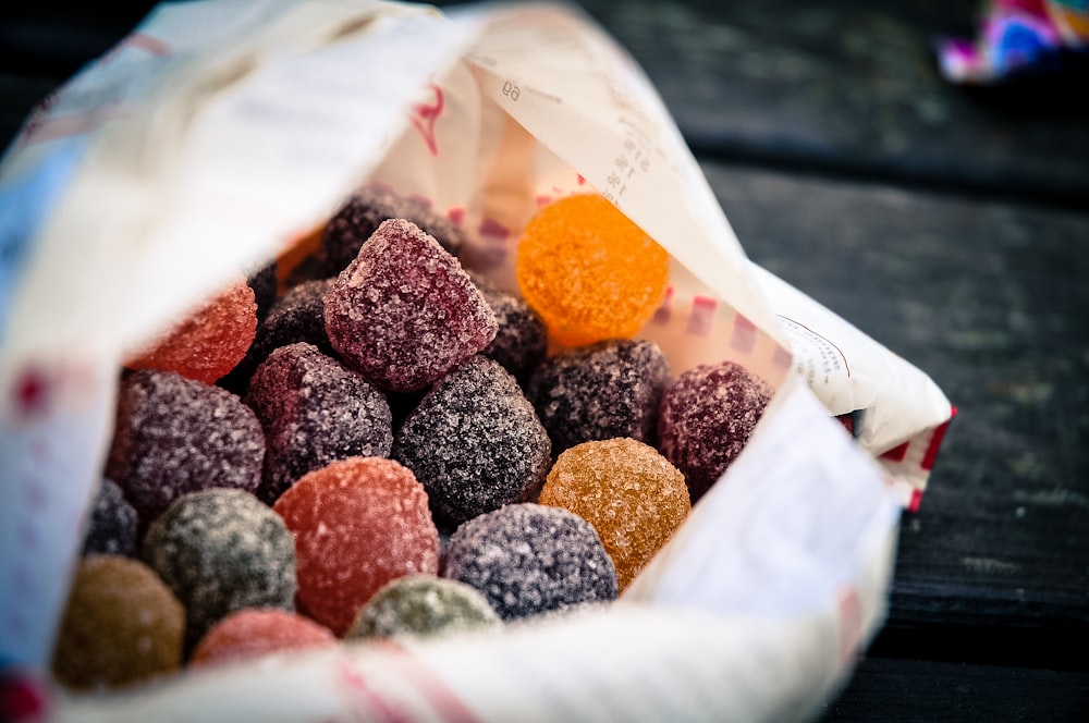 brown and red round fruits on white plastic container