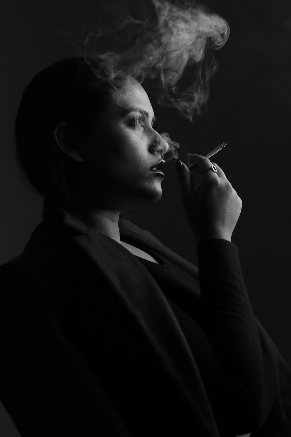 grayscale photo of woman smoking cigarette