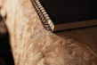 Close-up of hands writing in a beautifully designed journal with soft natural light