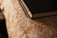Close-up of a handmade notebook with textured fabric cover and visible hand stitching.