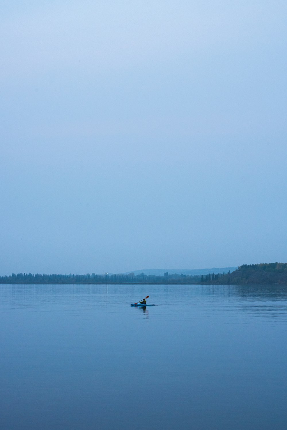 person in boat on lake during daytime