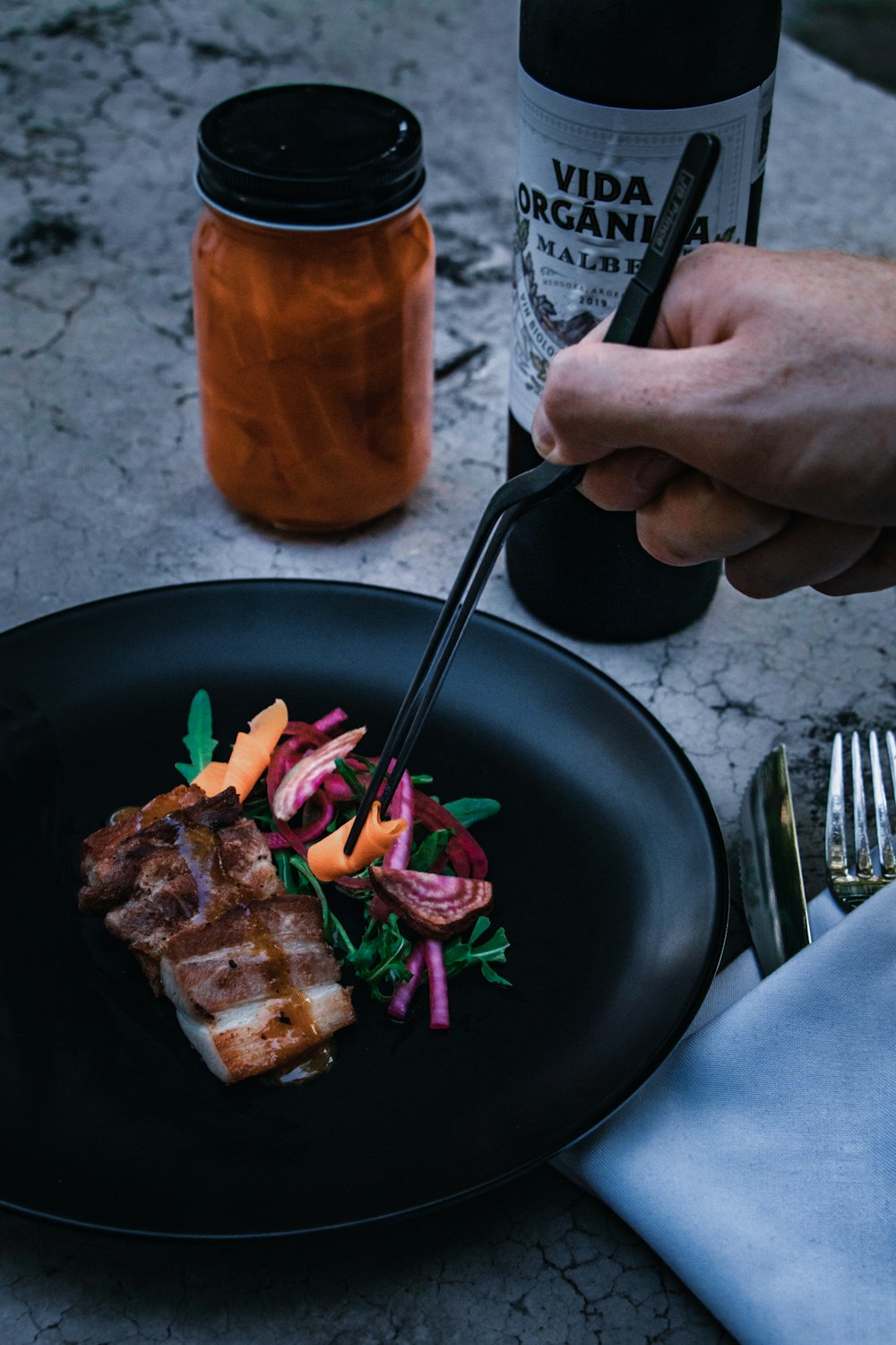 person holding stainless steel fork and knife