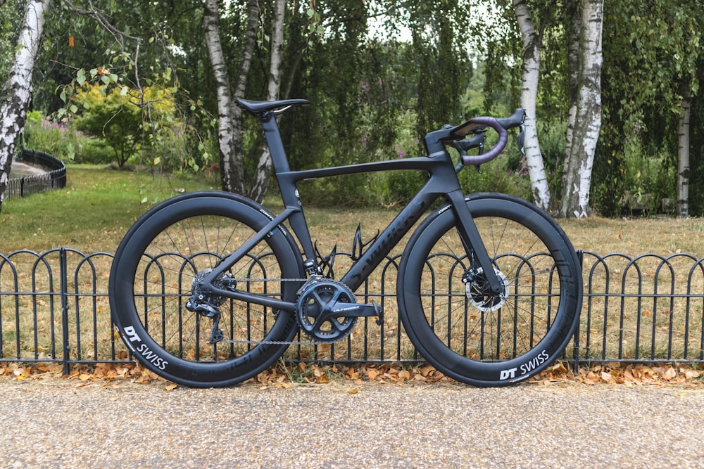 black and blue mountain bike on brown dirt road during daytime