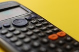 black remote control on yellow surface
