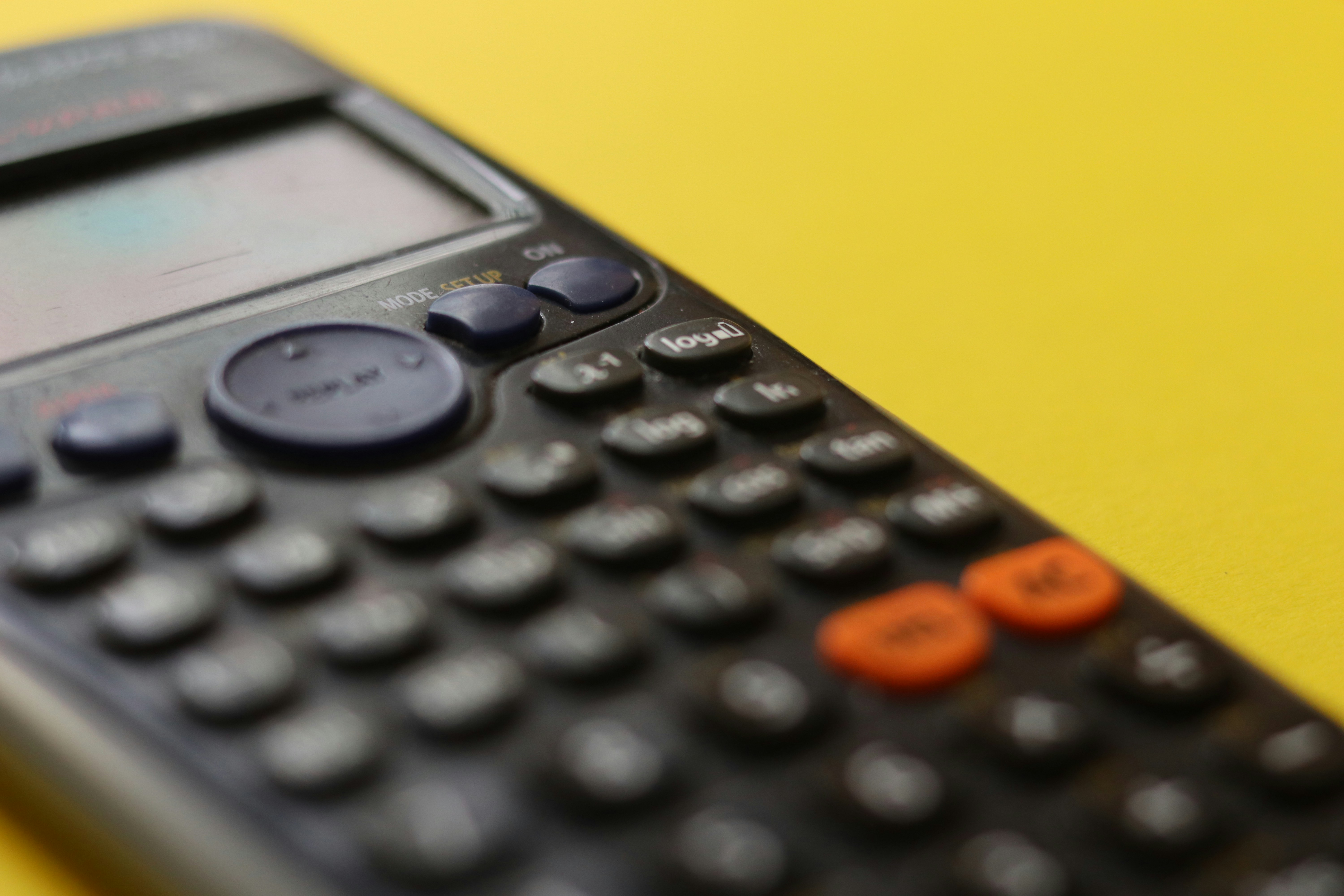 A calculator in a yellow background
