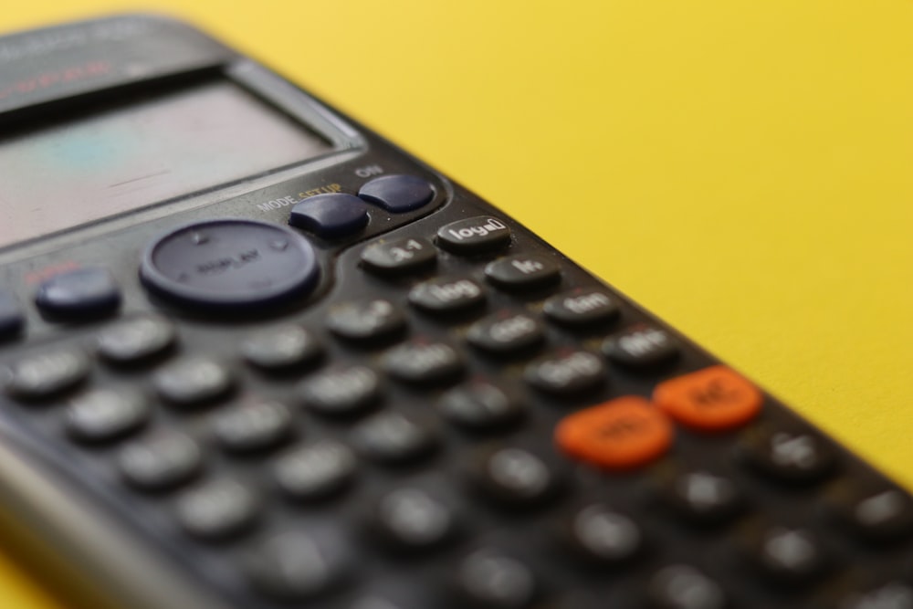 black remote control on yellow surface